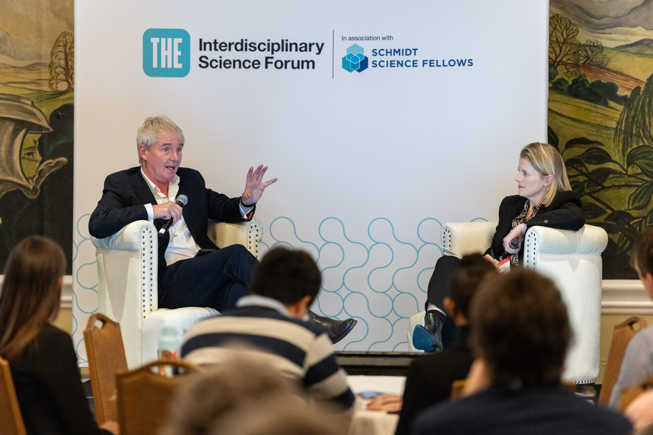 Professor Sir Nigel Shadbolt talks on stage at the Interdisciplinary Science Forum in 2024